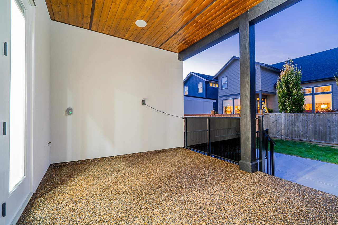 Covered entrance with warm wood soffit and modern glass front door